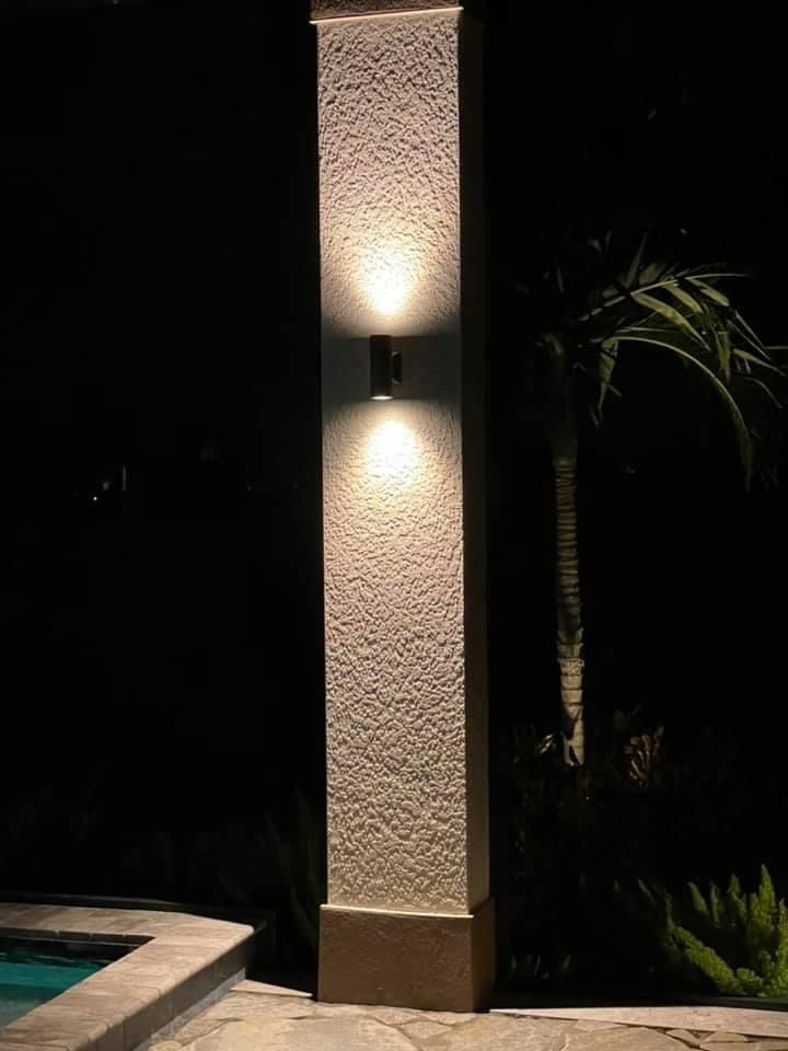 Close-up of column light fixture casting glow up and down