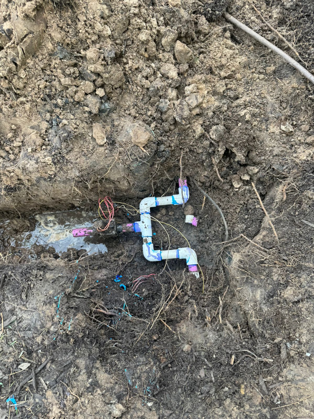 Open trench showing valve and drainage piping