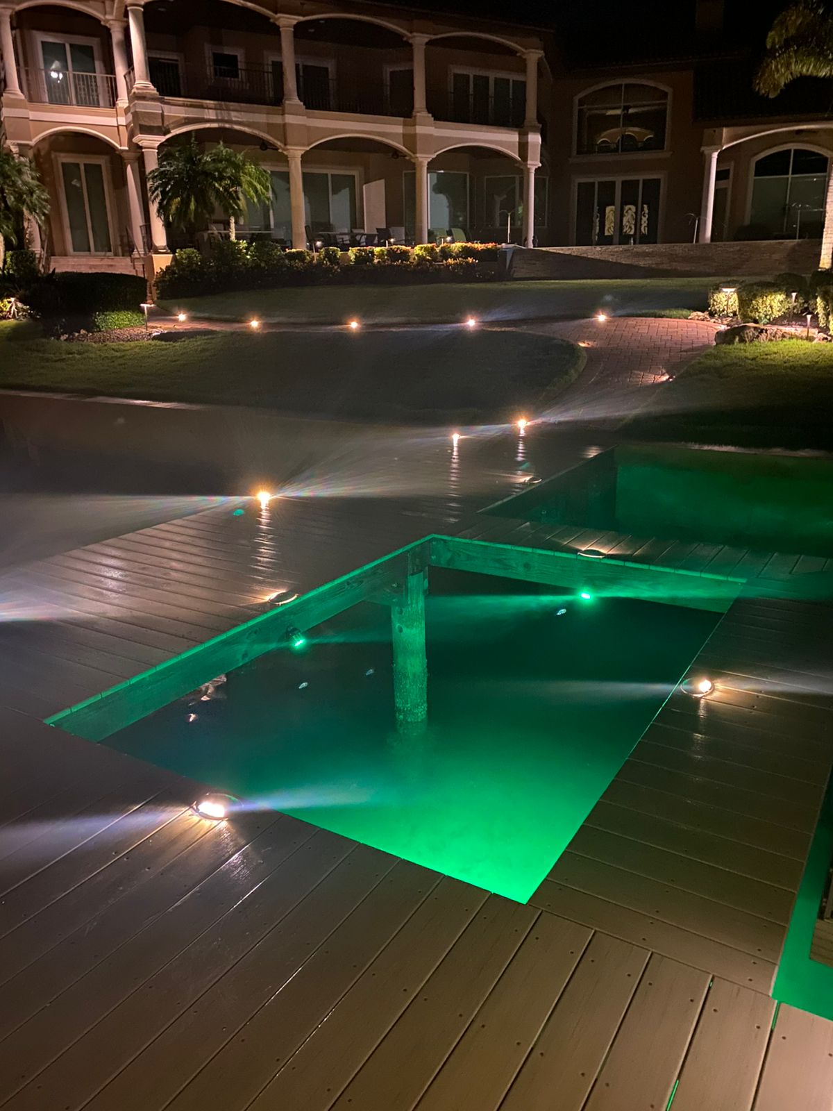 Large waterfront home with dock lighting