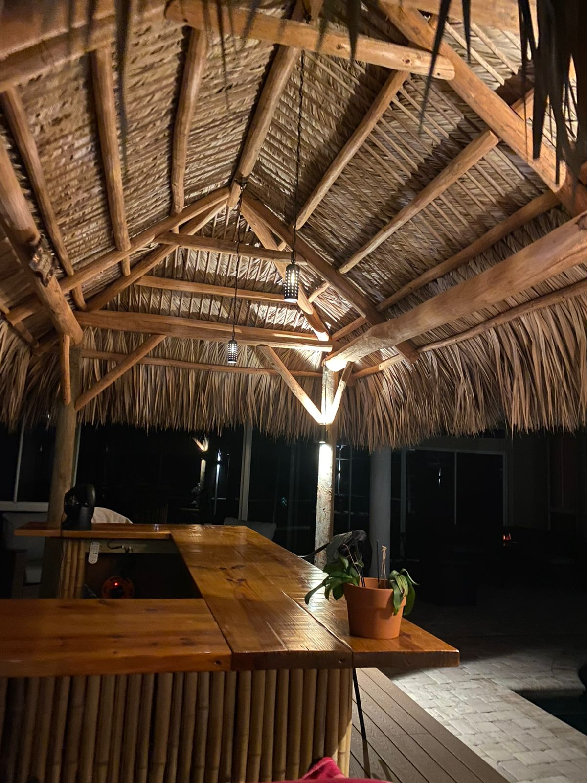 Tiki hut bar illuminated with warm fixtures